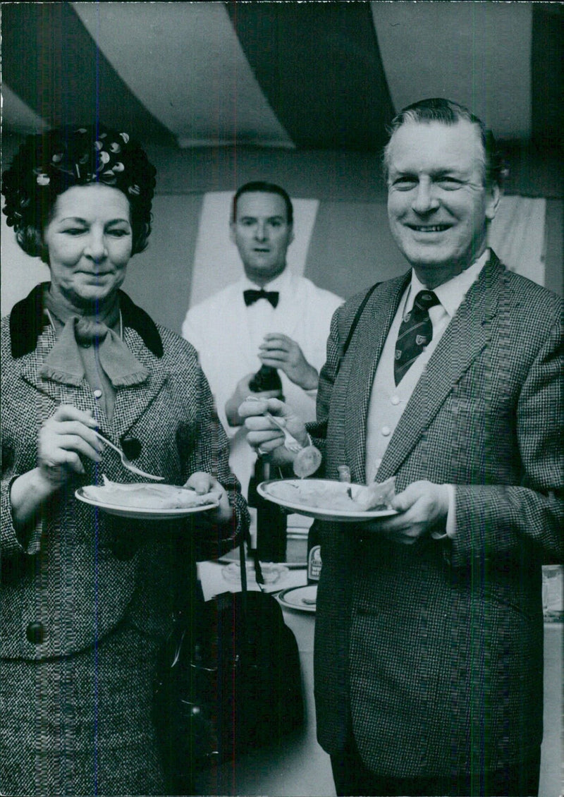 Mr. Donald Box, Conservative M.P. for Cardiff North enjoys a snack with his wife at the races - Vintage Photograph