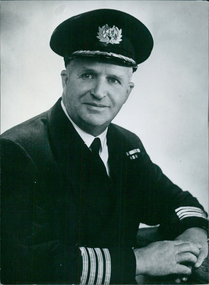 Captain David Aitchison, commander of the S.S. "Gothic", prepares to sail with Queen Elizabeth II and Prince Philip to New Zealand and Australia. - Vintage Photograph