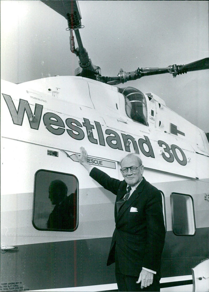 Lord Aldington, Chairman of Westland Aircraft Ltd, with one of his company's helicopters. - Vintage Photograph