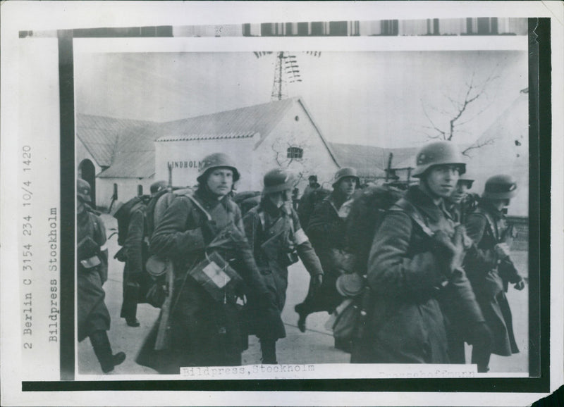 German military men marching along the streets of Denmark. - Vintage Photograph
