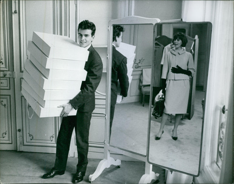 German actor, Horst Buchholz carrying boxes. - Vintage Photograph