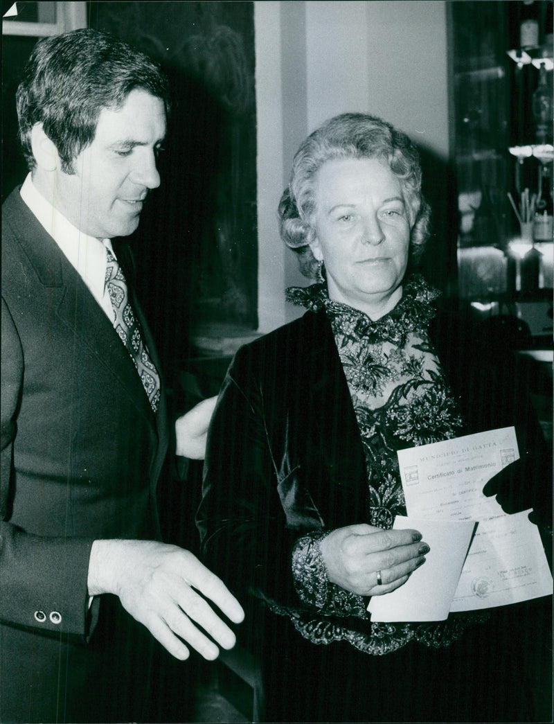Herbert Kappler and wife, Anneliese Kappler standing, showing documents.

1972
Kappler - Vintage Photograph