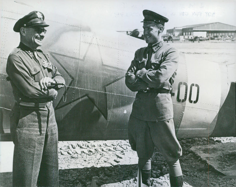Maj. Gen. Lowis H. Brereton standing and talking with Russian officer. - Vintage Photograph