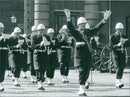 Soldiers marching in street during an event while playing music. - Vintage Photograph
