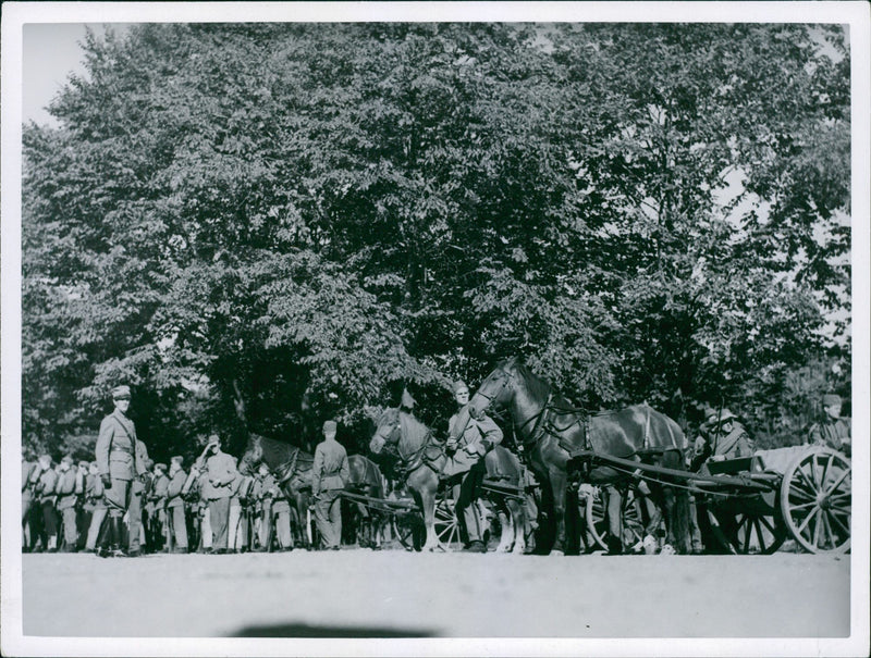 September 1937
A photo of military men standing preparing during an event. - Vintage Photograph