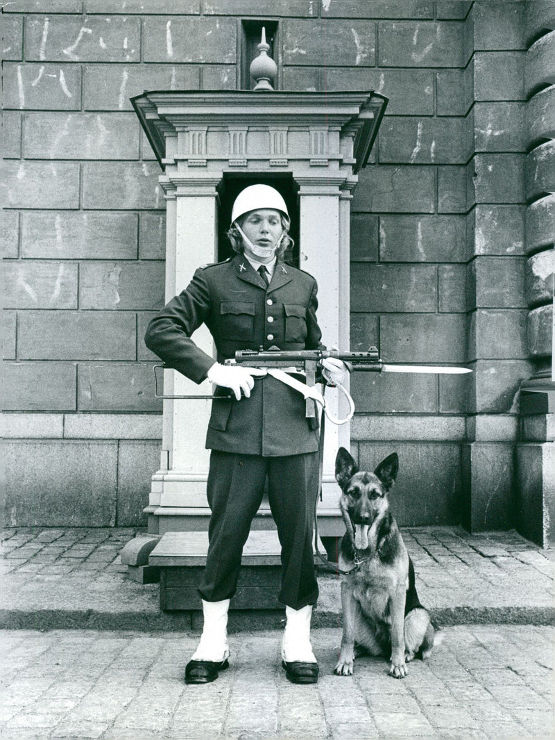 A royal guard standing with a dog and guarding. - Vintage Photograph