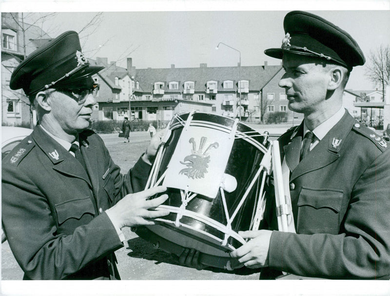 Military men standing and holding a drum. - Vintage Photograph