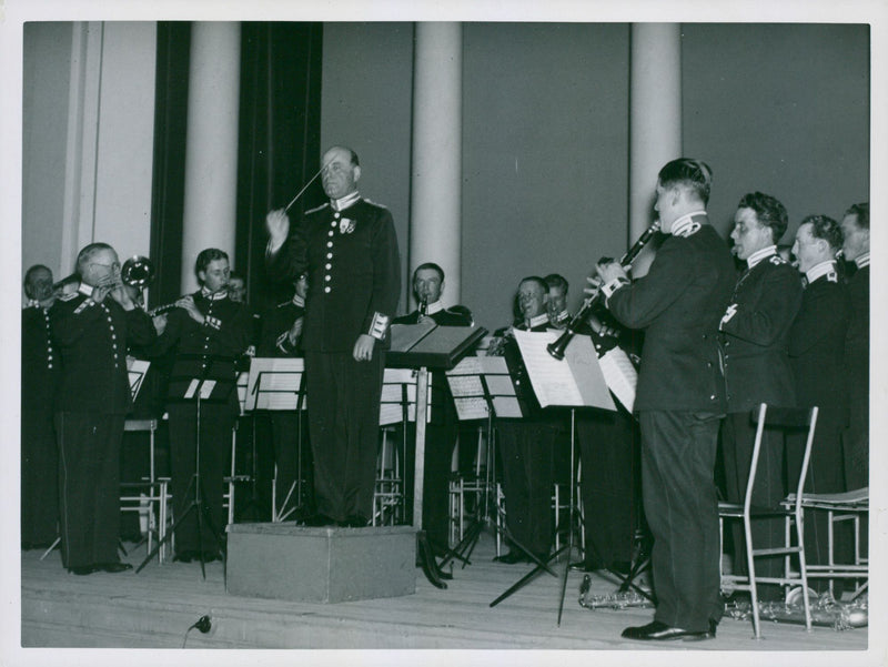 The Svea Life Guards band  standing together and playing music.

"Svea Lifeguards band"

1937 - Vintage Photograph