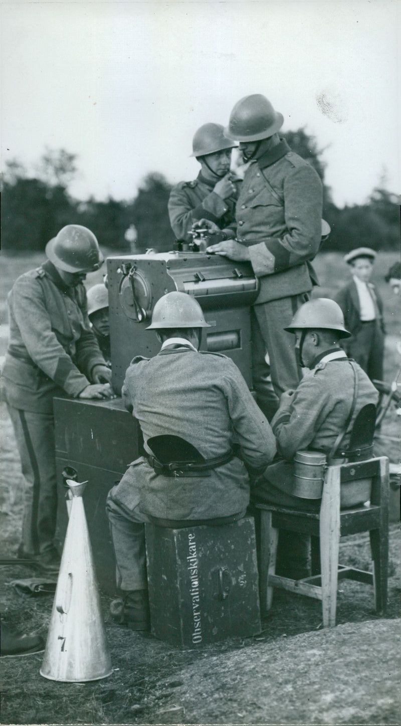 Svea Life Guards gathered operating a machine. - Vintage Photograph