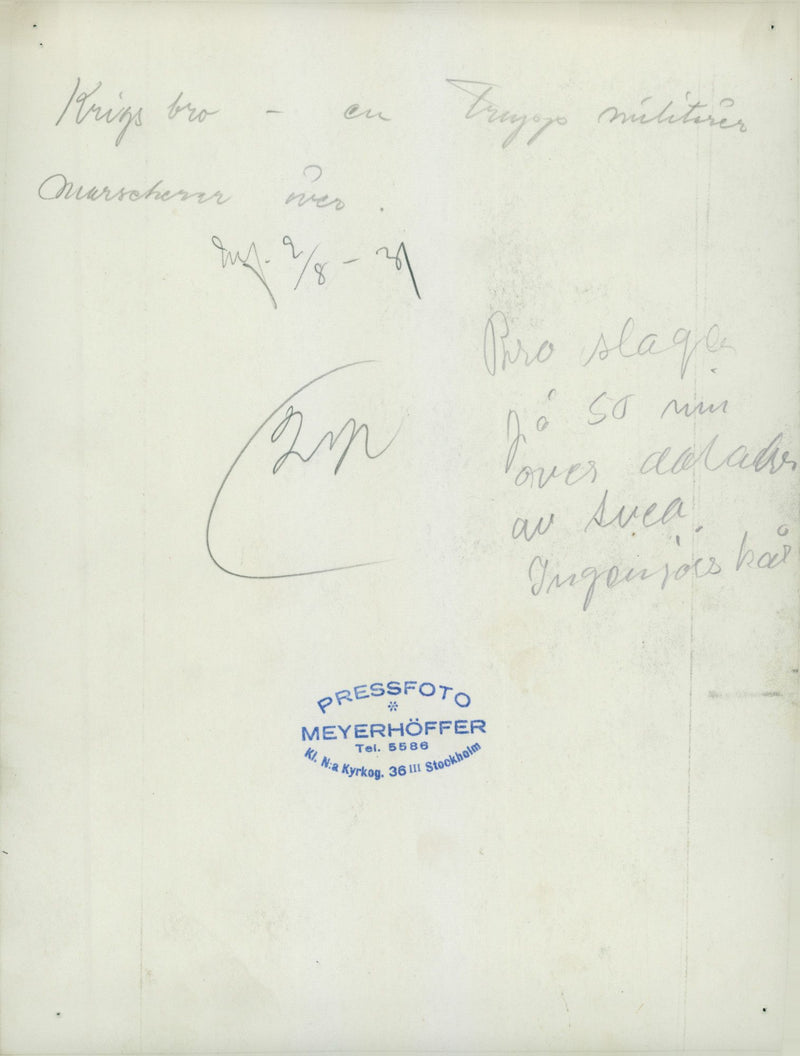 Soldiers marching across a war bridge built by the Svealand Engineer Regiment. - Vintage Photograph