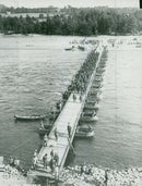 Soldiers marching across a war bridge built by the Svealand Engineer Regiment. - Vintage Photograph