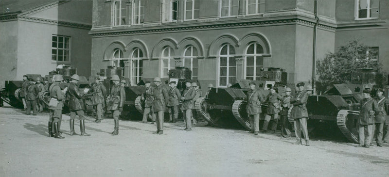 A photo of soldiers standing on their post beside them are military tankers. - Vintage Photograph