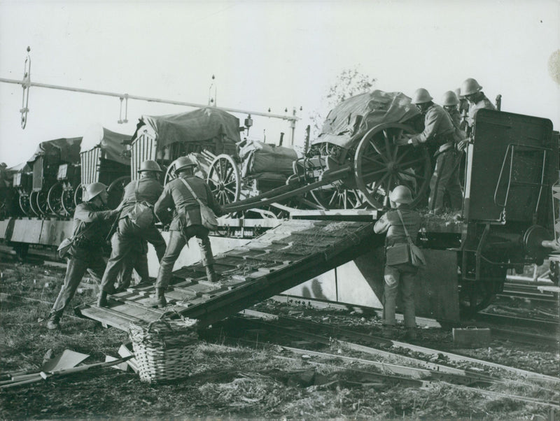 Soldiers unload wagons from the train at the autumn maneuver. - Vintage Photograph