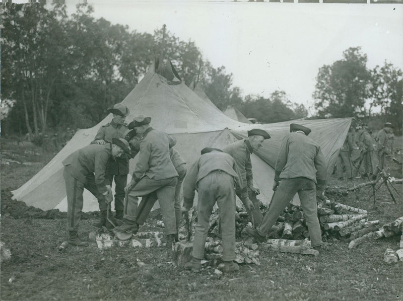 Military at their camp cutting some logs during field maneuver, 1931. - Vintage Photograph