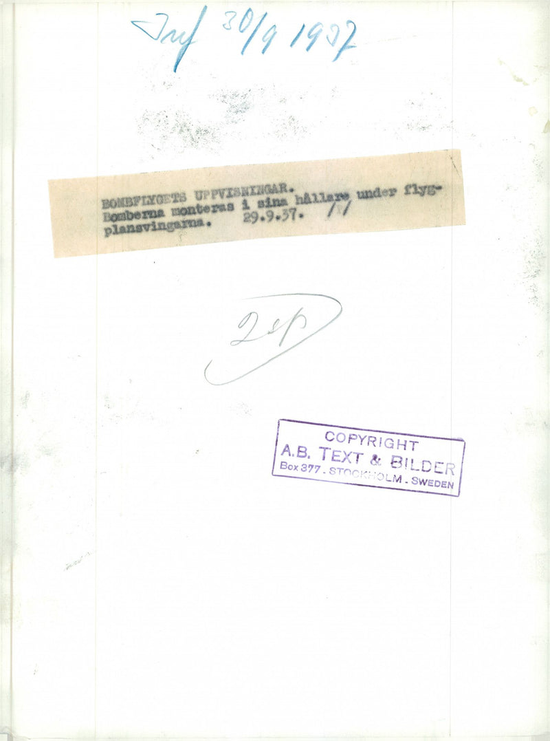 Bomb aircraft display, the bombs are mounted in brackets under the aircraft wings - 20 September 1937 - Vintage Photograph