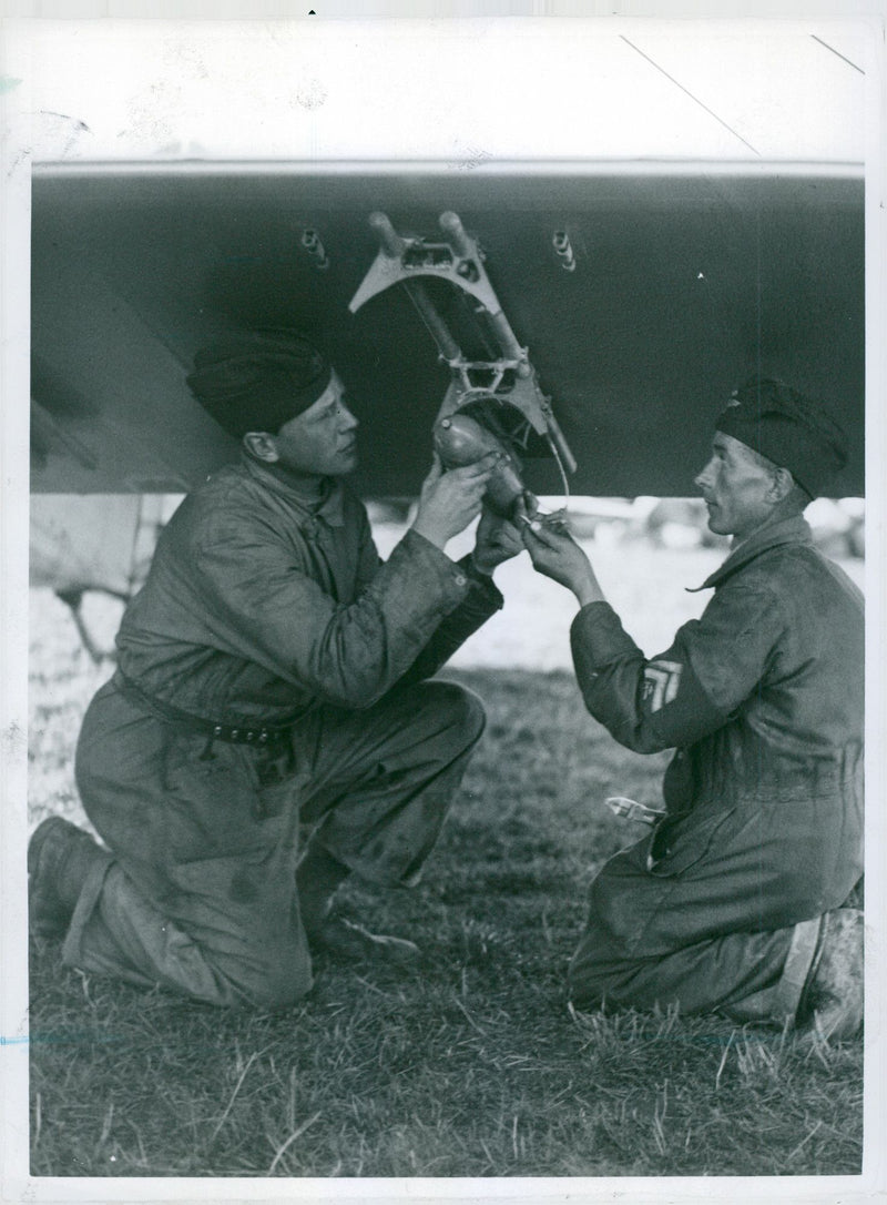 Bomb aircraft display, the bombs are mounted in brackets under the aircraft wings - 20 September 1937 - Vintage Photograph