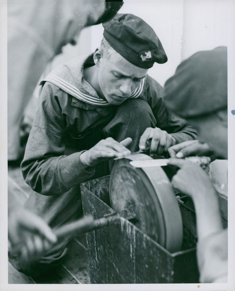 The Navy men aboard the Practice vessel Najaden, seen sharpen knives - Vintage Photograph