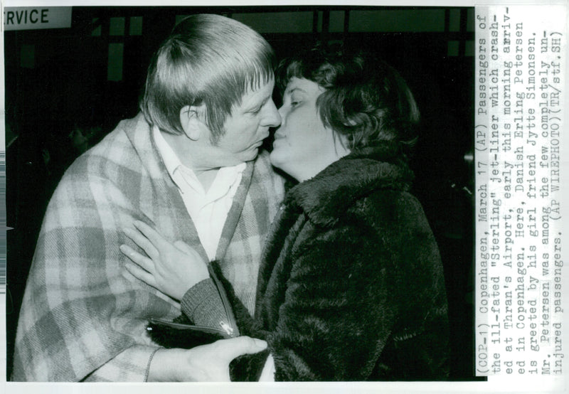 Survivors of the Sterling Airways flight arrived at Copenhagen airport. Erling Petersen is greeted by his girl friend. - Vintage Photograph