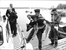 A police dog carried on board a police patrolboat to the troubled archipelago. - Vintage Photograph