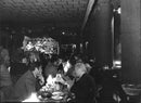 Lovely atmosphere with food, live music and drinks inside a nice restaurant. - Vintage Photograph