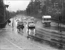 View of a street in a rainy day.Rainy day with the car traffic on the bridge running on a highwayView, street, rainy, day. - Vintage Photograph