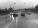 Cars driving in the rain, the road flooded - Vintage Photograph