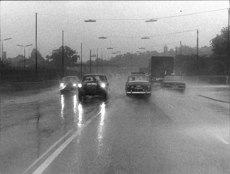 Cars driving in the rain, the road flooded - Vintage Photograph