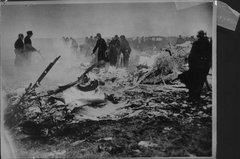 Firefighters extinguish fire from aircraft wreckage after a plane crash at Kastrup in Copenhagen, Denmark. - Vintage Photograph