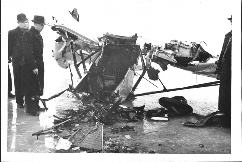 Aviation accident where men stand and look at the wreckage of the aircraft. - Vintage Photograph