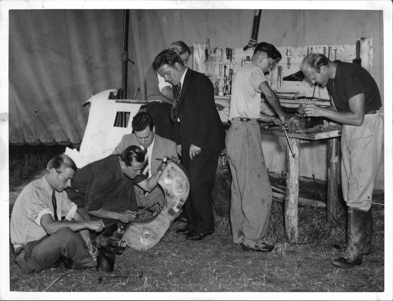 Six of the students and the flight mechanic repair aircraft damage in Stigtomta hangar tents. - Vintage Photograph