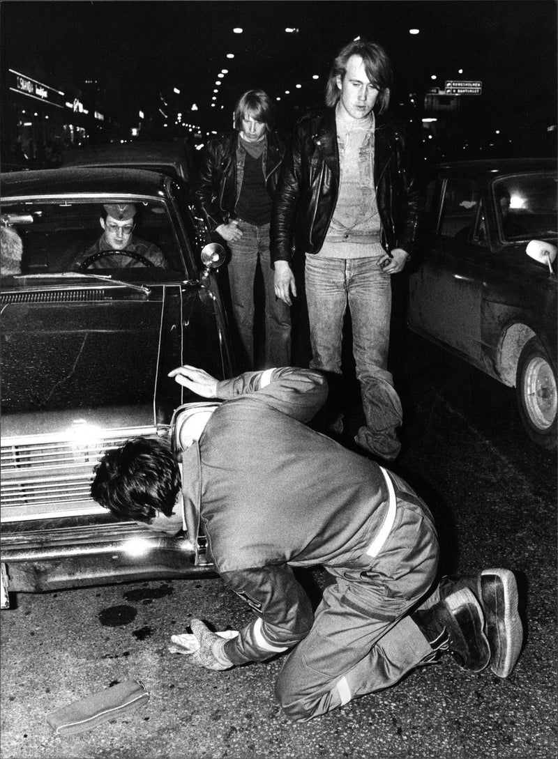 Arne Krook from the Safety Office examines a hot rod on SveavÃ¤gen: - Vintage Photograph
