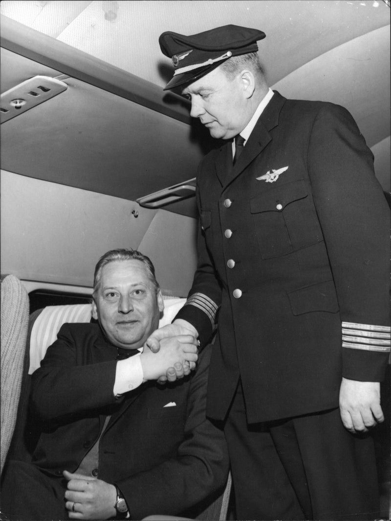 Engineer Sven Claesson being welcomed aboard by Captain Lasse Heikinaro - Vintage Photograph