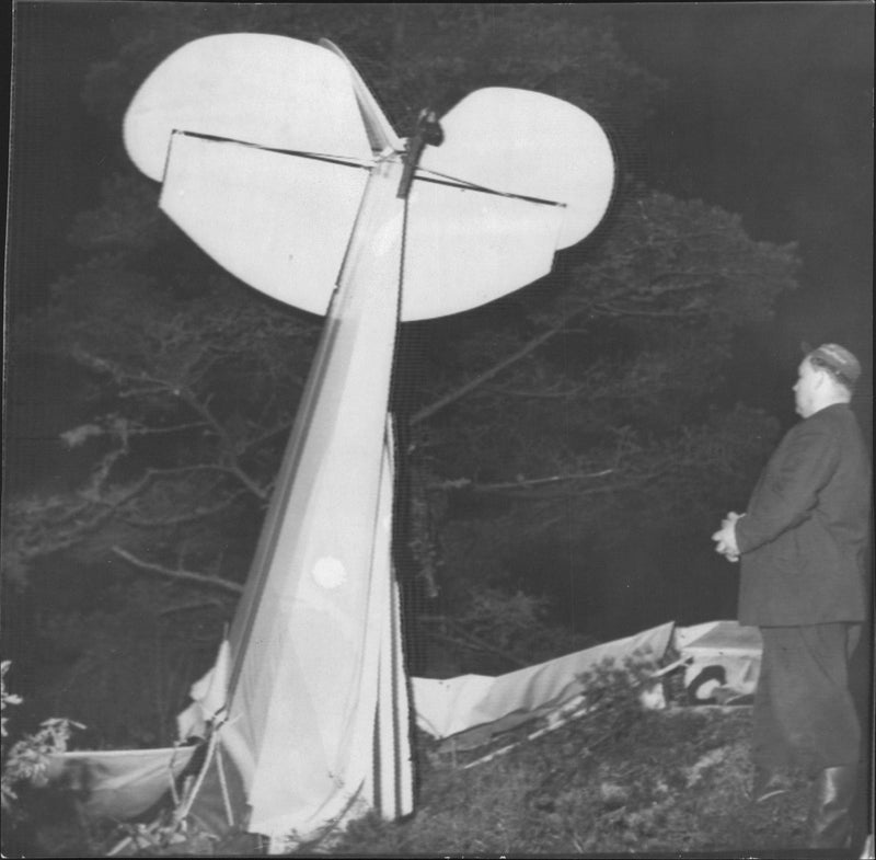 Aviation accident in which a man inspects a crashed aircraft. - Vintage Photograph