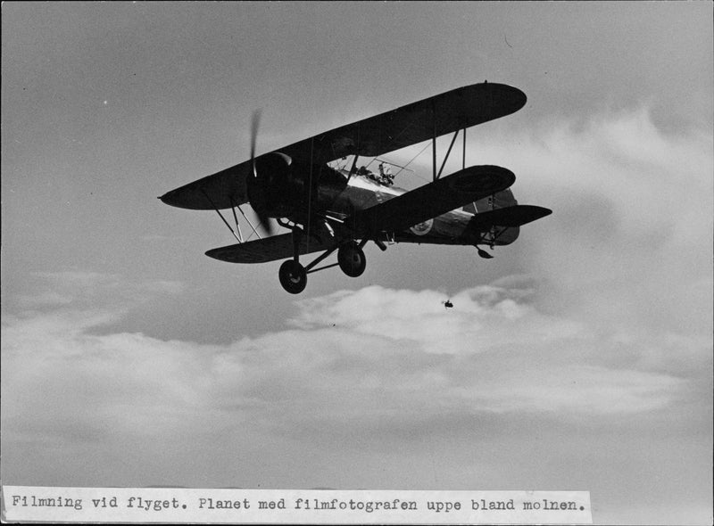 Film at the flight. Planet with the movie photographer up among the clouds - 1 August 1943 - Vintage Photograph