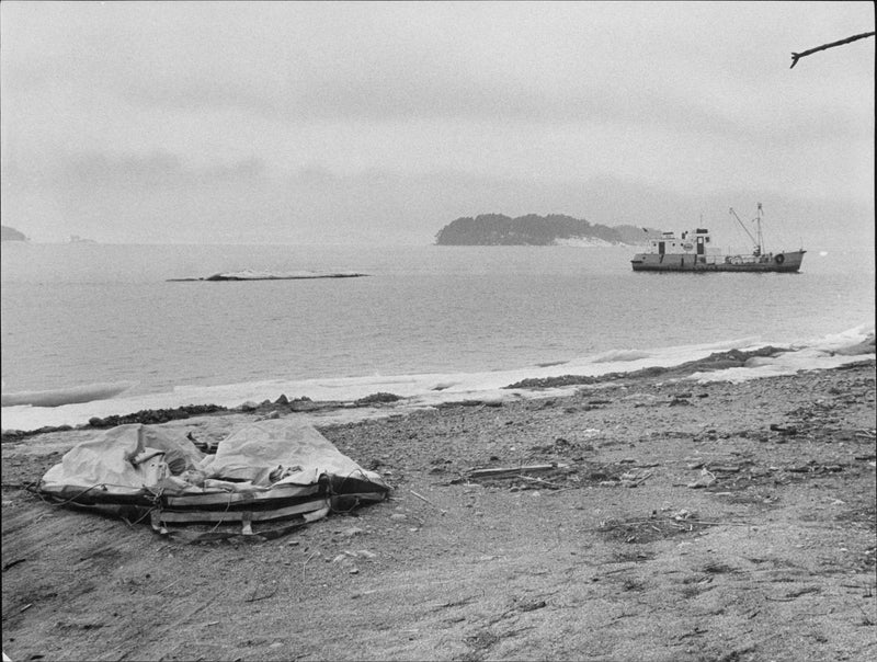 Liferaft drained of lifting lying on the beach after the thieves escape, tanker Risholmen in the background - Vintage Photograph