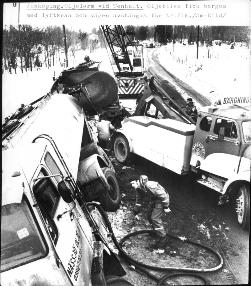 Tanker in the ditch. With the help of a crane and salvage truck, the tank truck could be pulled out of the ditch - Vintage Photograph