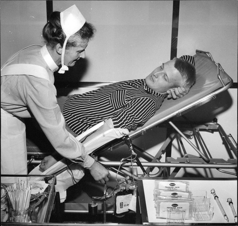 Sister Rachel take blood samples of student Stefan during blood research congress - Vintage Photograph