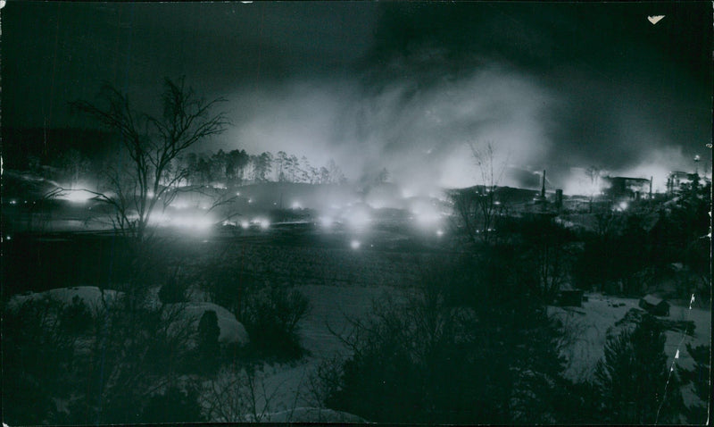 Explosion Fire in AB Nynas Petroleum oil refinery. Full Nynashamn illuminated by the glow from the burning oil tanks. - Vintage Photograph