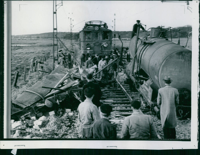 Clearing Crew in the process of getting derailed tank car on track after a collision with a freight train. - 14 October 1943 - Vintage Photograph