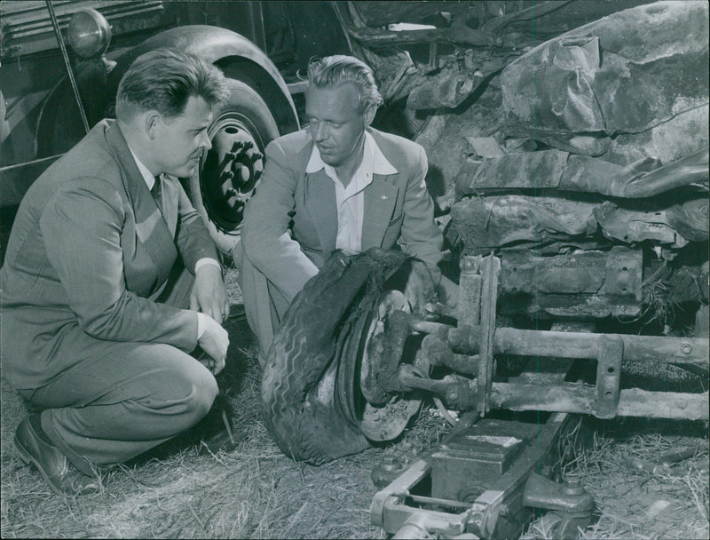 Engineer Hansson at the Automotive Testing Station examines the wreckage of the Volkswagen car - Vintage Photograph