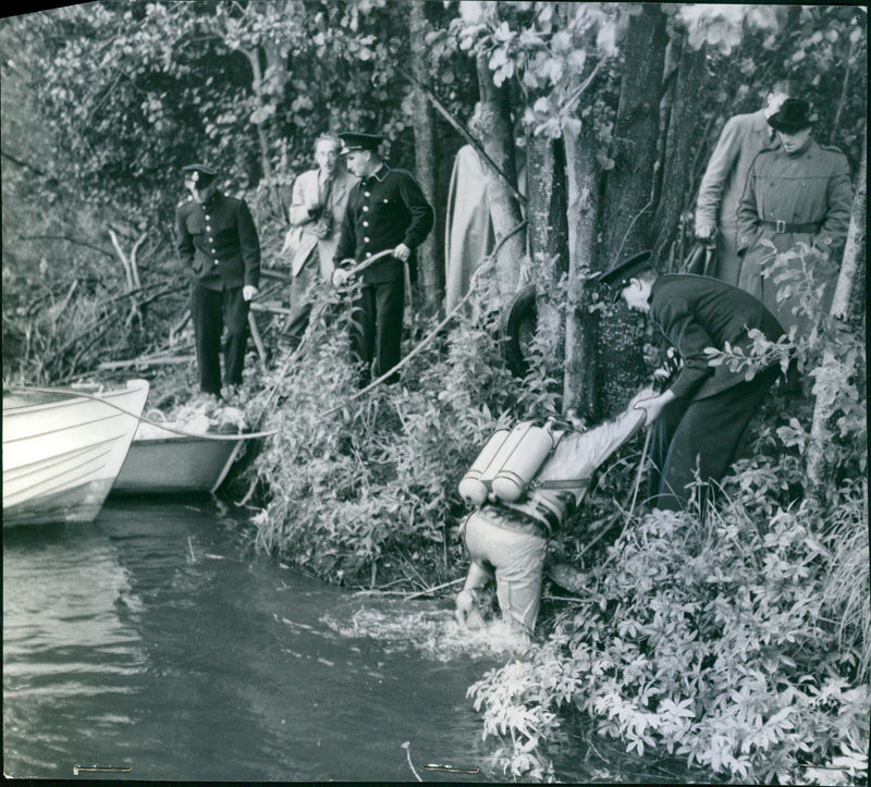 Frogman Lennart Holm helped up out of the water after about 20 minutes of searching in the beach area in connection with the murder of Kerstin Blom. - Vintage Photograph