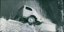 Car collision degenerated and one of the cars crashed down in the channel - Vintage Photograph