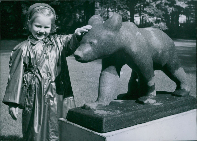 Marie-Louise Henriksson admire the sculpture "The Bear" by Lars Andersson at the Garden Society of Gothenburg exhibition "Sculpture in nature." - 17 August 1949 - Vintage Photograph