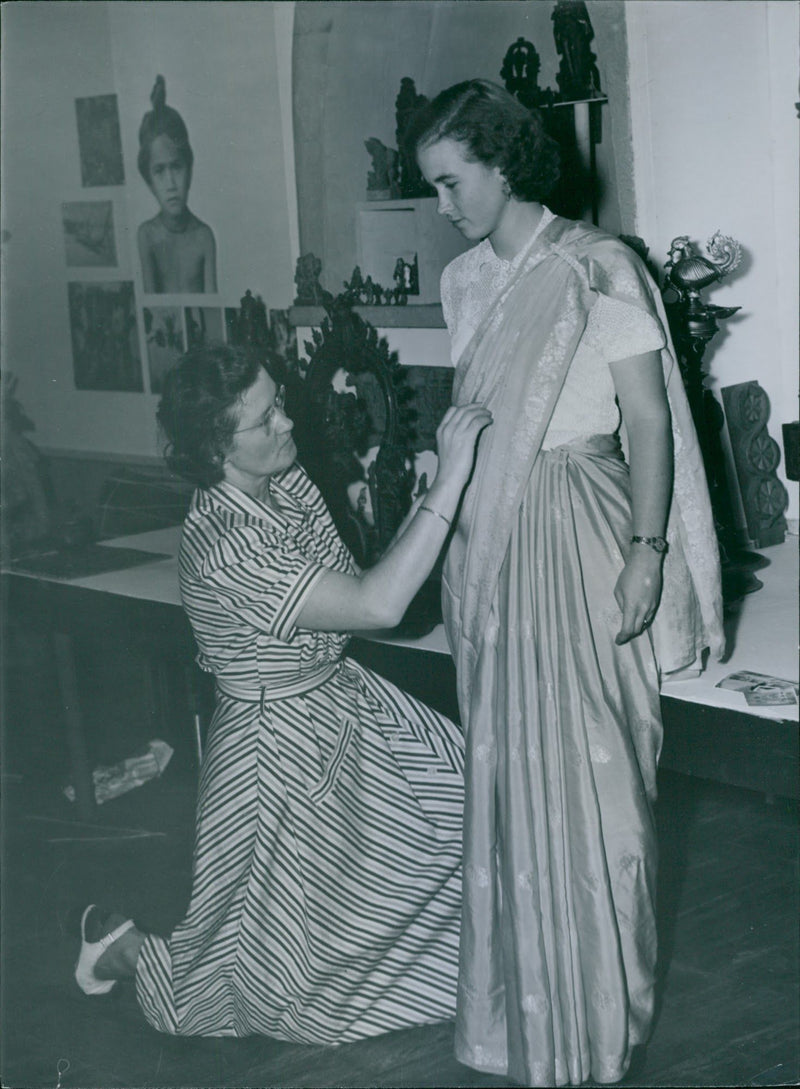 Mrs. Ingrid dress her dottter Elizabeth in an Indian sari during the Swedish Church's missionary exhibition - Vintage Photograph