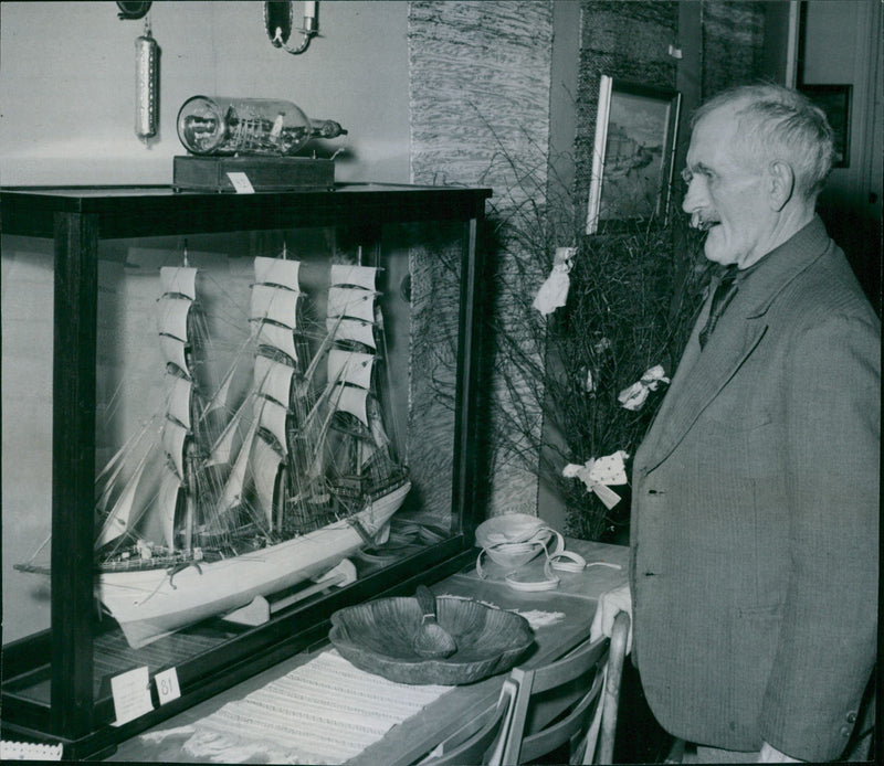 Timmerman Hultgren looks at one of his own-owned ships at the old exhibition booth - 28 March 1947 - Vintage Photograph