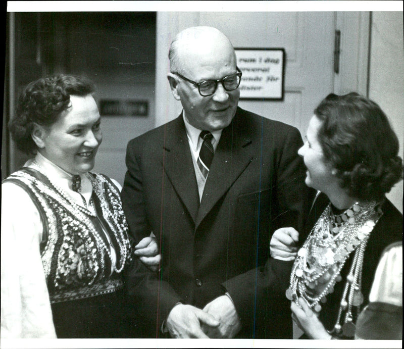 The 39th anniversary of the Estonian Republic is celebrated in the Concert Hall. Minister Hinrich Laratei together with the nationally dressed wives Ella Raudsepp and Anne Roop - Vintage Photograph
