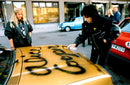 Alice Cooper spray-sign a car - Vintage Photograph