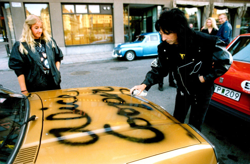 Alice Cooper spray-sign a car - Vintage Photograph