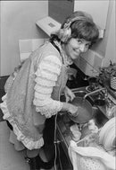 Inger Berggren can not be without music even when she counters - Vintage Photograph