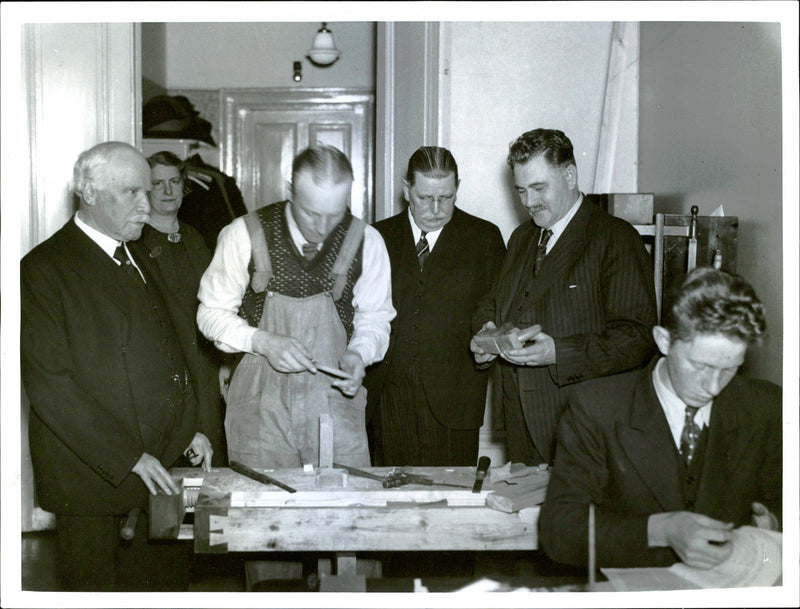 Delegates looking at a man that planes - 8 December 1936 - Vintage Photograph